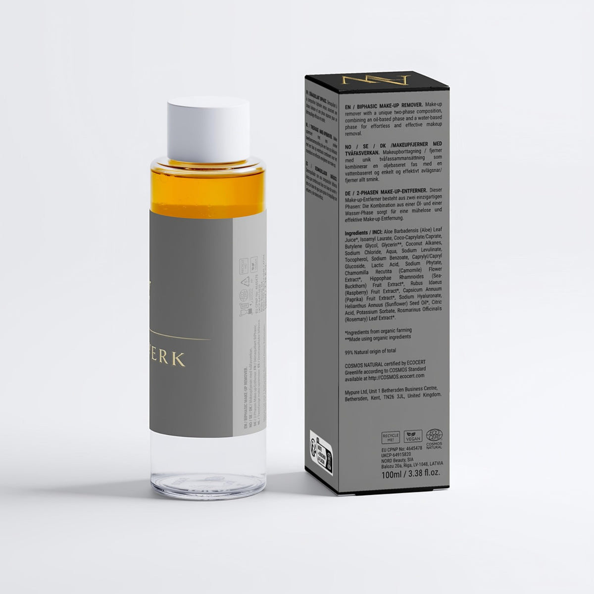 ENTHÜLLUNG Flasche und schwarze Faltschachtel in der Rückansicht mit Produktangaben auf weißem Hintergrund.